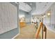 Well lit modern condo hallway with community board and seating area at 7240 W Custer Ave # 301, Lakewood, CO 80226