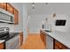 Kitchen with stainless appliances, quartz counters, and hardwood floors at 7240 W Custer Ave # 301, Lakewood, CO 80226