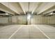 Interior view of a concrete parking garage with marked parking spots and visible ceiling at 7240 W Custer Ave # 301, Lakewood, CO 80226