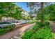 Exterior view of condos with street parking and lush greenery along sidewalk at 7240 W Custer Ave # 301, Lakewood, CO 80226