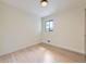 Empty bedroom with hardwood floors and a bright window at 920 S Hudson St, Denver, CO 80246