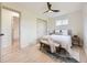 Bright bedroom with hardwood floors, ceiling fan, and a comfortable queen size bed with bench at 920 S Hudson St, Denver, CO 80246