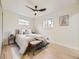 Bright bedroom with hardwood floors, ceiling fan, and a comfortable queen size bed with bench at 920 S Hudson St, Denver, CO 80246