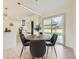 Dining area with a modern table and chairs, adjacent to the kitchen and featuring sliding glass doors to the yard at 920 S Hudson St, Denver, CO 80246
