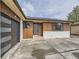 Close up of the entrance of the property, highlighting the front door, garage door, and wooden accents at 920 S Hudson St, Denver, CO 80246