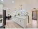Open concept kitchen with white cabinets, modern appliances, and a large island with plenty of storage space at 920 S Hudson St, Denver, CO 80246