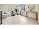 Bright and airy living room featuring hardwood floors, two white chairs, a sofa, and views of the outdoors at 920 S Hudson St, Denver, CO 80246