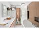 Bright bathroom with a double vanity, glass shower, and soaking tub, perfect for relaxation at 720 S Clayton St, Denver, CO 80209