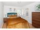 Warm bedroom with a comfortable bed, plantation shutters, and a matching nightstand and dresser set at 720 S Clayton St, Denver, CO 80209