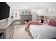 Cozy bedroom featuring a brick fireplace, plush bedding, and a well-lit vanity area under the window at 720 S Clayton St, Denver, CO 80209