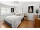 Bright bedroom featuring white walls, plantation shutters, and a comfortable bed with decorative pillows at 720 S Clayton St, Denver, CO 80209