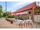 Exterior view of Bonnie Brae Ice Cream, with outdoor seating under red umbrellas at 720 S Clayton St, Denver, CO 80209