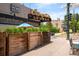 Exterior of Campus Lounge with patio, plants, and the Campus Lounge sign at 720 S Clayton St, Denver, CO 80209
