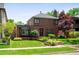 Charming two-story brick home with a well-manicured lawn and landscaping at 720 S Clayton St, Denver, CO 80209