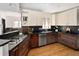Well-equipped kitchen with stainless steel appliances, dark counters and custom cabinets at 720 S Clayton St, Denver, CO 80209