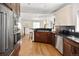 Kitchen featuring stainless steel appliances, custom cabinets and wooden floors at 720 S Clayton St, Denver, CO 80209