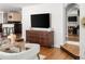 Inviting living area with hardwood floors, a modern entertainment center, and an open view to other living spaces at 720 S Clayton St, Denver, CO 80209