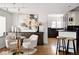 Open-concept living space with modern décor, flowing seamlessly into a kitchen with bar stool seating at 720 S Clayton St, Denver, CO 80209