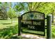 A sign for Bonnie Brae Park in a leafy green outdoor setting at 720 S Clayton St, Denver, CO 80209
