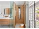 Luxurious glass shower boasts a modern shower panel and sleek design, adding style to this bathroom at 720 S Clayton St, Denver, CO 80209