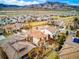 Aerial view of the homes featuring tile roofs, patios, and a mountain range in the background at 15275 W La Salle Ave, Lakewood, CO 80228