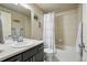 Bathroom featuring a shower-over-tub, a large vanity and mirror, and neutral walls at 15275 W La Salle Ave, Lakewood, CO 80228