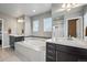 Bright bathroom featuring a soaking tub, walk-in shower, and dual vanities at 15275 W La Salle Ave, Lakewood, CO 80228