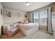 Charming bedroom with bright decor, natural light, carpet floors and a seating area at 15275 W La Salle Ave, Lakewood, CO 80228