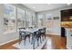 Bright dining room featuring hardwood floors and ample natural light from three large windows at 15275 W La Salle Ave, Lakewood, CO 80228