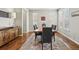 Elegant dining room with modern furnishings, rich hardwood floors, and abundant natural light at 15275 W La Salle Ave, Lakewood, CO 80228