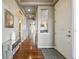 Inviting entryway featuring rich hardwood floors, modern decor, and ample natural light at 15275 W La Salle Ave, Lakewood, CO 80228