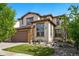 Inviting two-story home boasts a beautifully landscaped yard, stone accents, and a two-car garage at 15275 W La Salle Ave, Lakewood, CO 80228