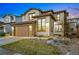 Exterior evening shot of a home with a two-car garage and stone accents at 15275 W La Salle Ave, Lakewood, CO 80228