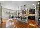 Open-concept kitchen with a large island, stainless appliances, and hardwood floors with breakfast nook at 15275 W La Salle Ave, Lakewood, CO 80228