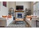 Cozy living room featuring a stone fireplace, two sofas, and decor shelves at 15275 W La Salle Ave, Lakewood, CO 80228