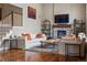 Cozy living room with a stone fireplace, hardwood floors, and comfortable seating at 15275 W La Salle Ave, Lakewood, CO 80228