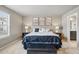 Spacious main bedroom with a comfortable bed and access to ensuite bathroom at 15275 W La Salle Ave, Lakewood, CO 80228