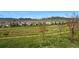 Scenic view of a neighborhood with walking paths and mountain backdrop on a sunny day at 15275 W La Salle Ave, Lakewood, CO 80228