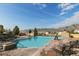Community pool featuring lounge chairs and mountain views on a clear, sunny day at 15275 W La Salle Ave, Lakewood, CO 80228