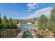 Stairway view of a community pool overlooking houses and mountains in the distance at 15275 W La Salle Ave, Lakewood, CO 80228