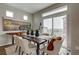 Bright dining room with modern table, chairs, a large window, and stylish decor at 1163 Highview Dr, Erie, CO 80516