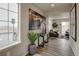Welcoming entryway featuring a decorative table, large windows, and an inviting view into the living room at 1163 Highview Dr, Erie, CO 80516