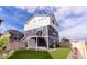 Back of gray and white home featuring an artificial turf yard and a balcony at 1163 Highview Dr, Erie, CO 80516