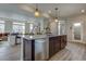 Kitchen island with dark cabinetry, stainless steel dishwasher, and an open view to the living area at 1163 Highview Dr, Erie, CO 80516
