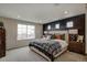 Serene main bedroom featuring a large window, stylish bedding, and accent wall at 1163 Highview Dr, Erie, CO 80516