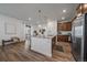 Modern kitchen with stainless steel appliances, granite countertops, and hardwood floors at 9536 Richfield St, Commerce City, CO 80022