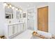 Bright bathroom features a double sink vanity, gold hardware, and walk-in shower at 5055 W 33Rd Ave, Denver, CO 80212