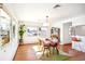 Cozy dining area featuring hardwood floors, ample light, and stylish modern furnishings at 5055 W 33Rd Ave, Denver, CO 80212