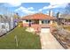 Beautiful home featuring lush green lawn, brick accents, and a cozy, inviting entrance at 5055 W 33Rd Ave, Denver, CO 80212