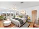 Bright main bedroom featuring hardwood floors, a gray bed and large windows at 5055 W 33Rd Ave, Denver, CO 80212